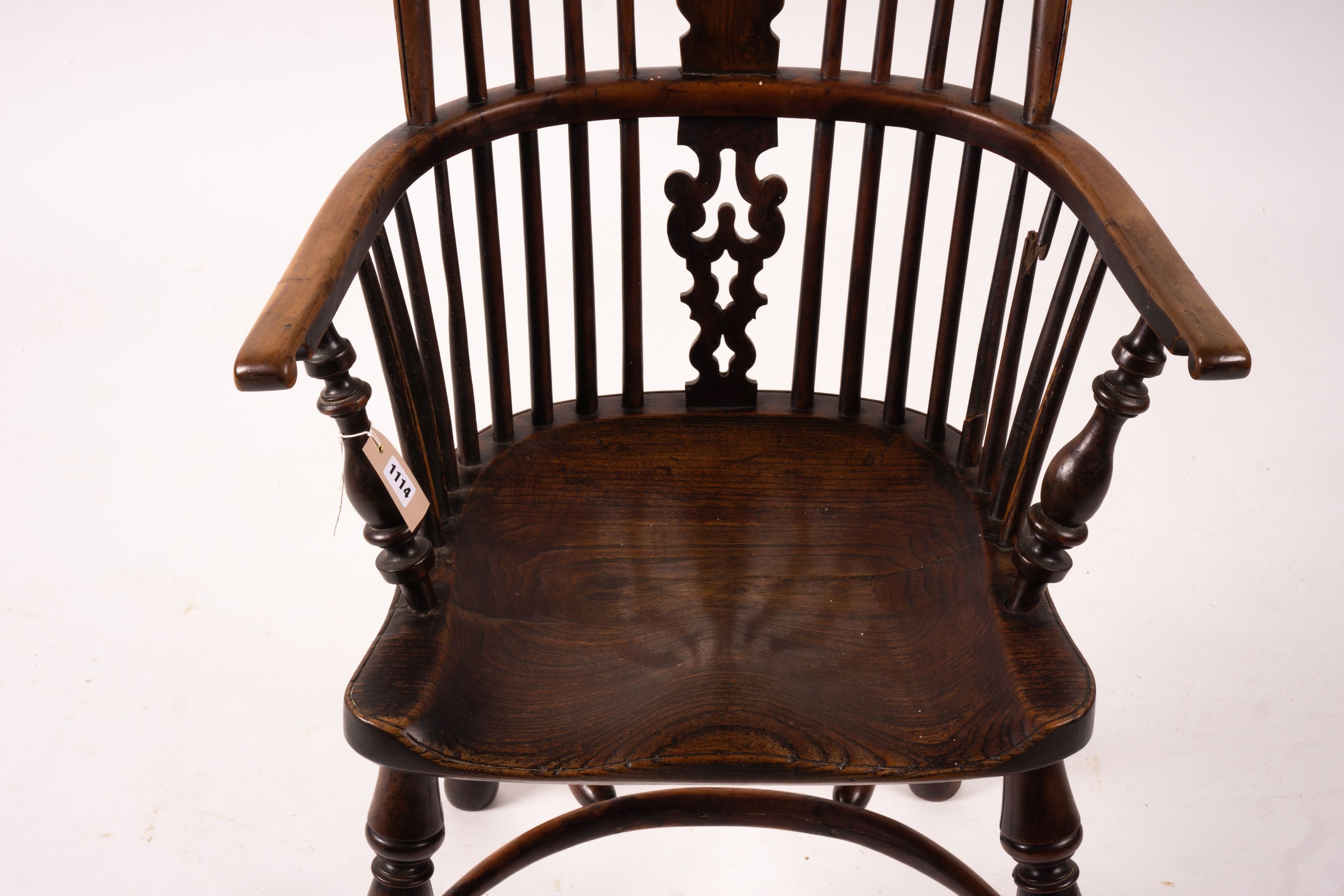 A mid 19th century yew and elm Yorkshire area Windsor armchair with saddle-seat and crinoline stretcher, width 63cm, depth 47cm, height 110cm